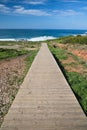 Scenic seascape empty wooden pathway leading to atlantic ocean with waves Royalty Free Stock Photo