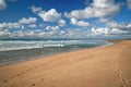 Tranquility scene of empty sand beach with footprints, and beautiful cloudy sky background