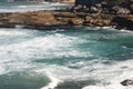 Idyllic and amazing seaside landscape of jagged coast with rocks and rushing white ocean waves Royalty Free Stock Photo