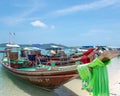 Scenic shot of a beach with sailboats in the shallow waters of the ocean in Krabi, Thailand