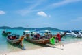 Scenic shot of a beach with sailboats in the shallow waters of the ocean in Krabi, Thailand