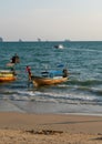 Scenic shot of a beach with sailboats in the shallow waters of the ocean in Krabi, Thailand