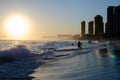 Scenic shot of beach with sea waves in Barra da Tijuca at sunset, Rio de Janerio