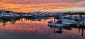 Scenic shot of boats docked on a marina during a sunset