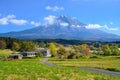 Scenic shot of the famous Mount Fuji behind a rural locality on a sunny summer day Royalty Free Stock Photo