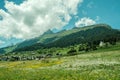 Scenic shot of a field on the foot of the Brigels Breil Mountains in Grisons, Surselva, Switzerland Royalty Free Stock Photo