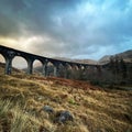 Scenic shot of the Harry Potter bridge in Scotland under the gloomy stormy sky