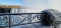 Scenic shot of an iced metal fence in front of the Niagara Falls in Canada in winter