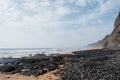 Scenic shot of the Praia do Cordoama beach in Algarve Portugal with black rocks and cliffs Royalty Free Stock Photo