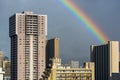 Scenic shot of a rainbow behind a series of modern buildings