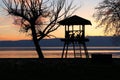 Scenic shot of silhouettes of people in a gazebo on the shore of Lake Ohrid during beautiful sunset Royalty Free Stock Photo