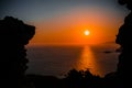 Scenic shot of the sunset taken from the cave in Castle of Monolithos, Greece