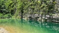 Scenic shot of the transparent water surface with the reflection of a rocky hill on its surface