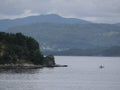 Scenic shot of two small fishing boats floating in a Norwegian fjord next to a small boat shed Royalty Free Stock Photo