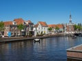 Scenic shot of the waterfront buildings of the city of Alkmaar under the blue sky, The Netherlands