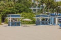 Scenic sight of two service kiosks positioned across from hotel on sandy shores of Miami Beach.