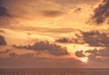 Scenic sky sunset with sun sea horizon with clouds orange background