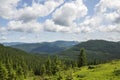 Scenic skyscape with blue sky full of windy clouds, and beautiful green mountains. Carpathians, Ukraine Royalty Free Stock Photo