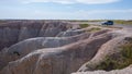 People taking dangerous photos right by the cliff in Badland national park during summer.