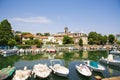 Scenic spring view of pier with ancient and modern buildings, ships, yachts and other boats in Rimini, Italy