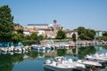 Scenic spring view of pier with ancient and modern buildings, ships, yachts and other boats in Rimini, Italy- June 21, 2017