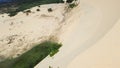 Scenic steep large white sand dunes, curved tracks and desert-like landscape with low scrub vegetation at Bau Trang, Bac Binh Royalty Free Stock Photo