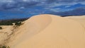 Scenic steep large white sand dunes, curved tracks and desert-like landscape with low scrub vegetation at Bau Trang, Bac Binh Royalty Free Stock Photo