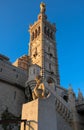 The scenic stone bell tower of Notre Dame de la Garde Basilica and cherub statue , Marseille, France. Royalty Free Stock Photo