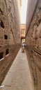 Scenic stone path adorned with Egyptian ancient hieroglyphics, as people gracefully tread in between Royalty Free Stock Photo