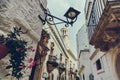 Scenic street and Morelli palace in white oldtown of Lorototondo, Italy