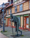 Scenic street scene in Wernigerode with vintage buildings and Skulptur "Die Rast" Royalty Free Stock Photo