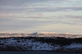 Scenic sunrise view from the shore of snowy mountains and river Royalty Free Stock Photo