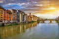 Scenic sunset cityscape over Arno River, St Trinity Bridge and colorful old houses along the river in Florence city Royalty Free Stock Photo