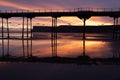 Scenic sunset cloudscape reflecting on the beach behind the Saltburn Pier Royalty Free Stock Photo