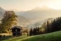 Scenic sunset in idyllic alpine mountain landscape with a traditional wooden lodge in fall Royalty Free Stock Photo