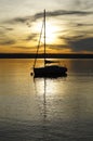 a scenic sunset on lake Ammersee with a sailing boat resting on the water (Herrsching on Ammersee in Germany)