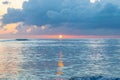 Scenic sunset off the coast of tropical Caribbean island. Sun just above the horizon. Royalty Free Stock Photo