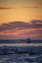 Scenic sunset over the iced St Lawrence River and a ship in Quebec, Canada