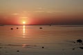 Scenic sunset over the sea. Reflection of the sun in water. The sky is painted with bright colors. Sunset beach in a summer Royalty Free Stock Photo