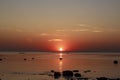 Scenic sunset over the sea. Reflection of the sun in water. The sky is painted with bright colors. Sunset beach in a summer Royalty Free Stock Photo