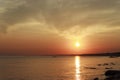 Scenic sunset over the sea. Reflection of the sun in water. The sky is painted with bright colors. Sunset beach in a summer Royalty Free Stock Photo