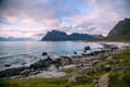Scenic sunset view on beach, ocean and mountains, Lofoten, Norway