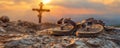 Scenic Sunset View with Cross on Mountain Peak and Pair of Sandals in Foreground Travel, Faith, and Serenity Concept