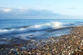 Scenic surf wave on rocky coastline