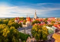 Scenic Tallinn summer cityscape with Saint Olav`s church and old town walls and towers at sunset, Estonia