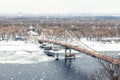 Scenic top panoramic view of Kyiv city pedestrian bridge over ice covered Dnieper river Trukhanov island park landscape Royalty Free Stock Photo