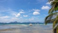 Scenic tropical panorama landscape. Palm tree and white boat on seashore during low tide. Philippines, island Palawan, El Nido. Royalty Free Stock Photo