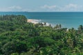 Scenic and tropical view from the top of a mountain of the empty Natives beach, with bright green native vegetation