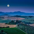 Scenic Tuscany landscape with rolling hills under full moon