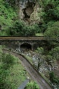 Scenic vertical shot of a stone bridge in the middle of the cliff of Jenolan Caves Royalty Free Stock Photo